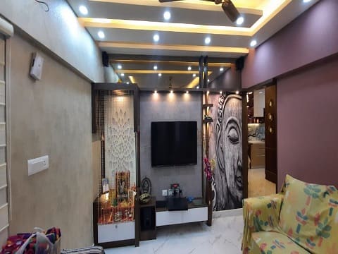 False ceiling created with yellow led strips and a visually attractive ceiling to go with the decor of the living room .Exclusively done by the false ceiling interior designers from hyderabad