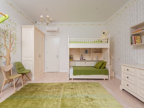 Furniture in this children's bedroom embraces the green and white  theme with a mix of functional and playful pieces.. A cozy bed with white and green-themed bedding becomes the focal point.