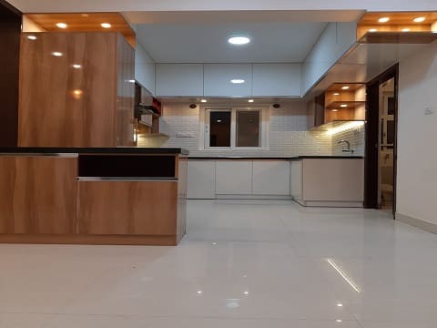 best kitchen interior design with an island table counter and led lights around the kitchen to brighten the space.The kitchen layout is in U-shaped as it is a spacios one
