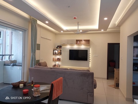 a compact space designed along with a living room and dining area of an apartment with led lighting and false ceiling  with a carefully curated blend of furnishings and decor.