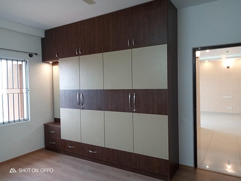 Tailored details, such as an attached dressing table with mirrior attached or specific storage compartments, ensure the wardrobe meets individual needs,this can be customised by the best wardrobe interior designs in hyderabad